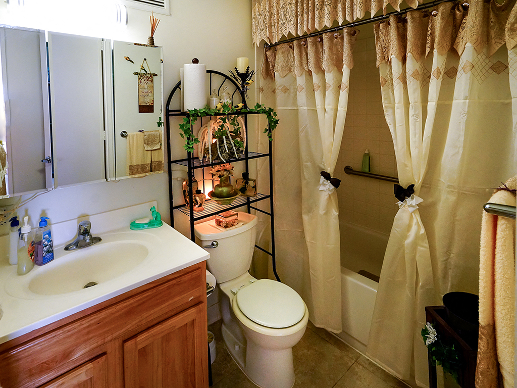 a bathroom with a toilet and a sink and a shower