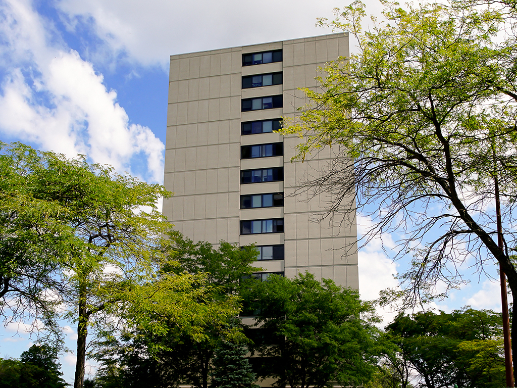 a tall building with trees in front of it
