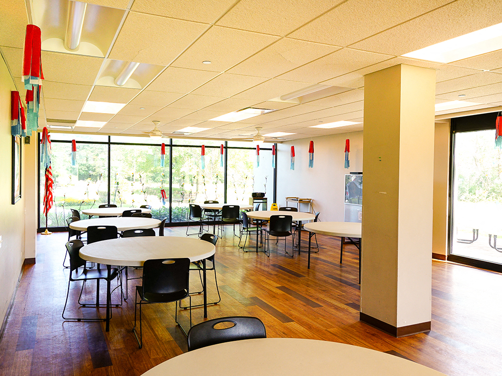 a dining room with tables and chairs in a cafeteria