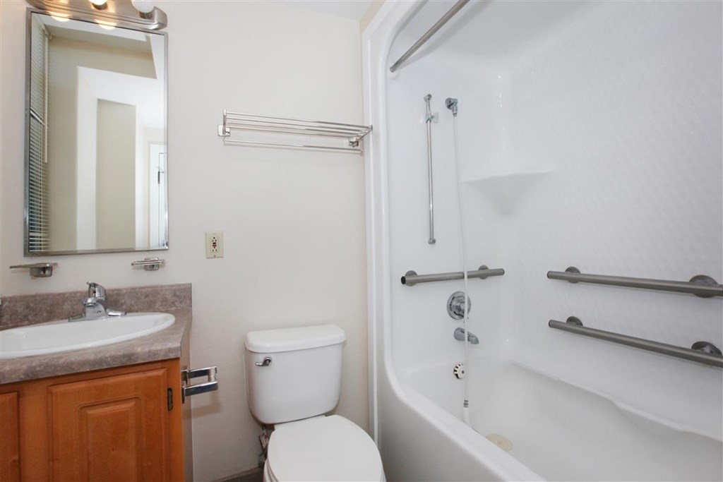 a bathroom with a sink toilet and a bath tub
