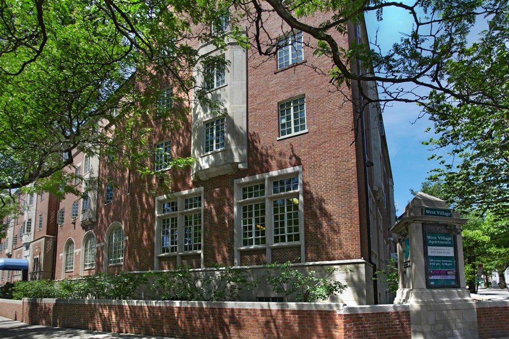 a large brick building with trees in front of it