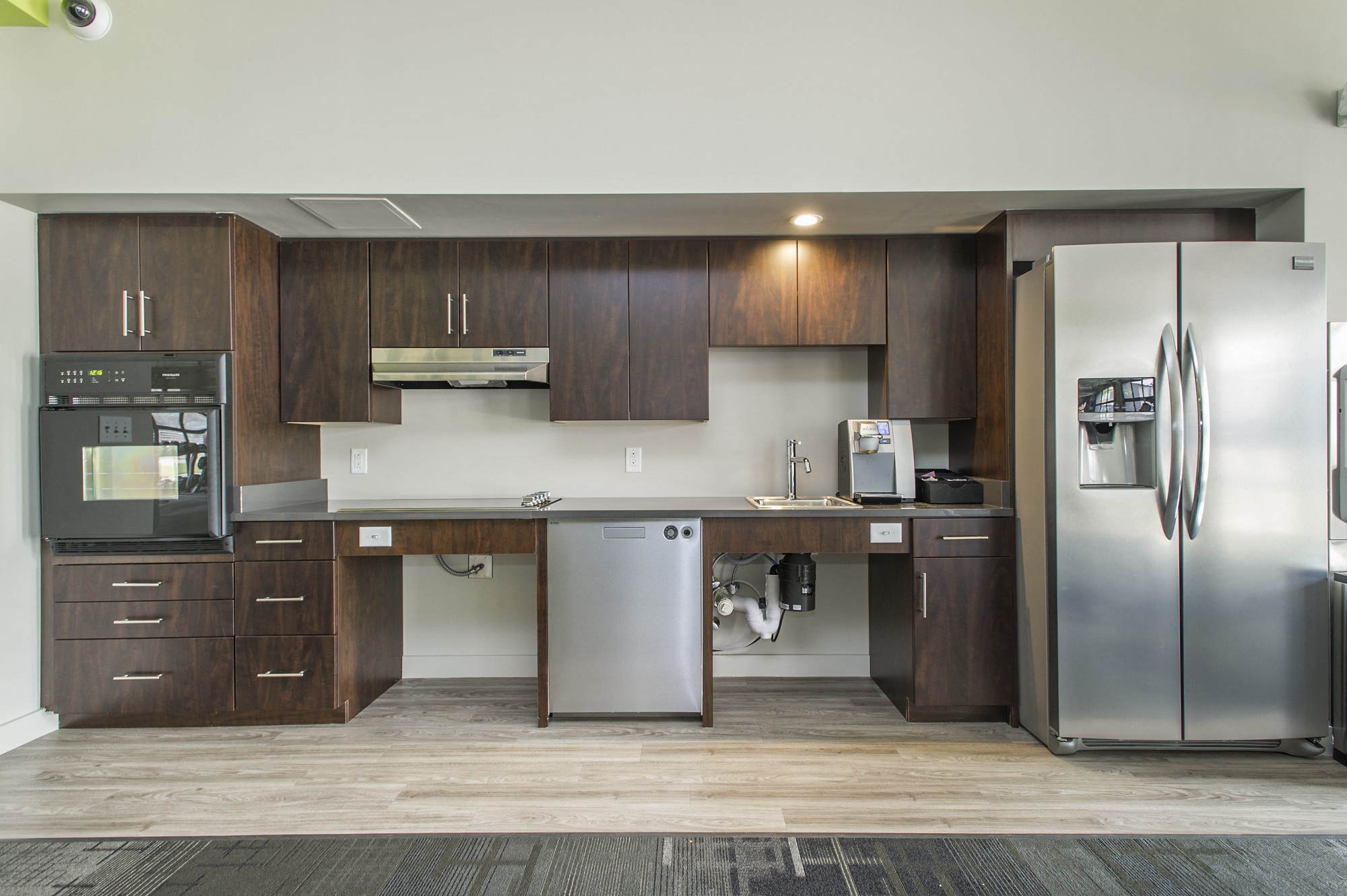 a kitchen with stainless steel appliances and wooden cabinets