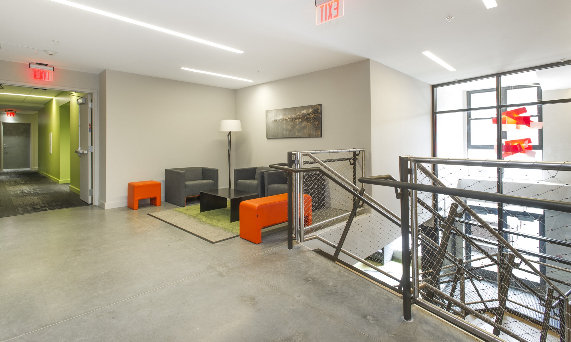 a room with couches and chairs in front of a glass door