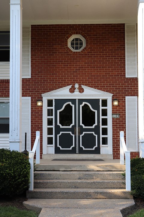 the front door of a church with a red brick building