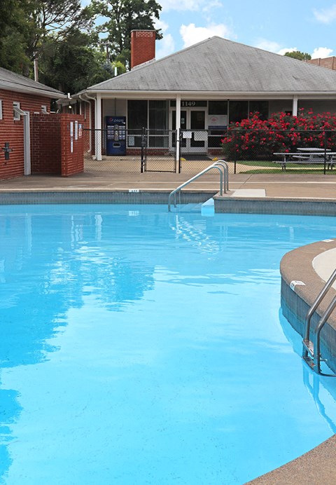 a large swimming pool with a building in the background