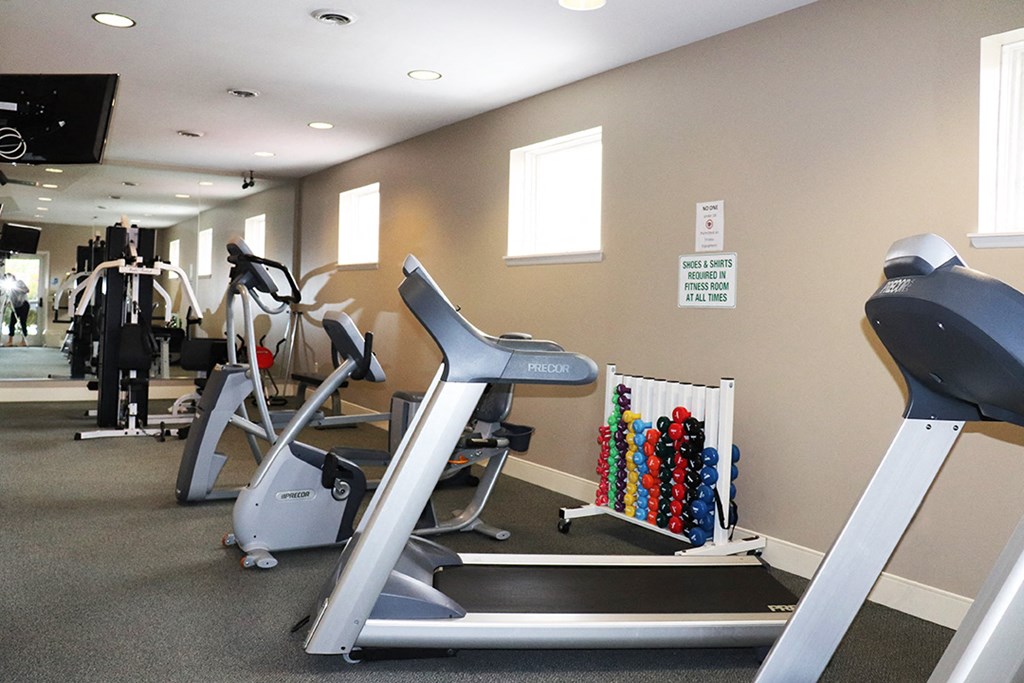 a gym with treadmills and other exercise equipment in a building