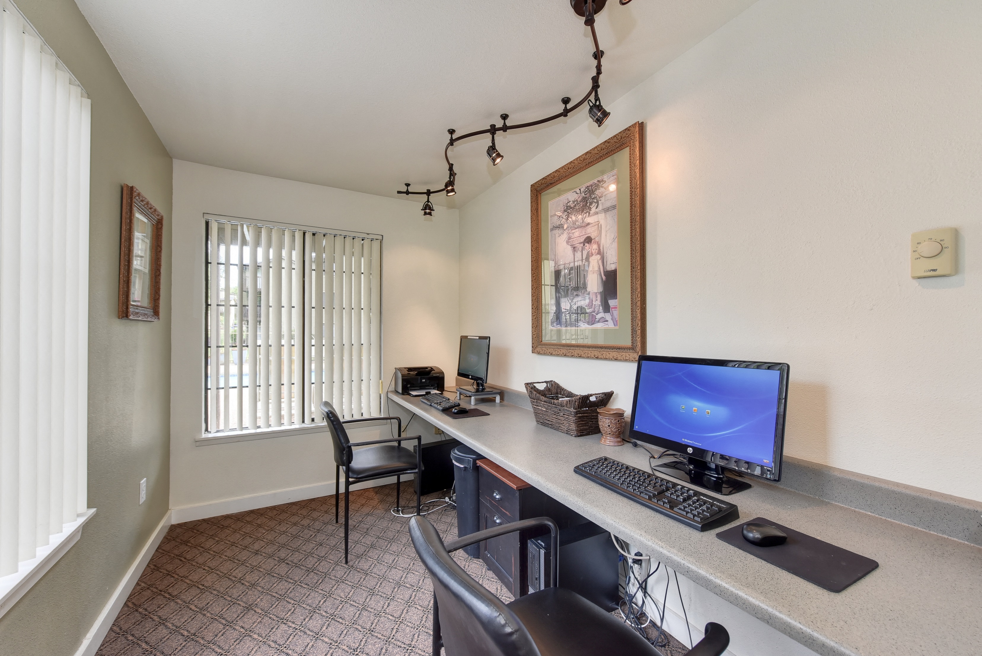 Community Business Center with Desk, Computer, Keyboard, Carpet and White Walls
