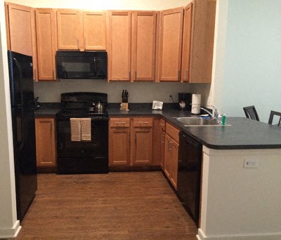 a kitchen with black appliances and wooden cabinets