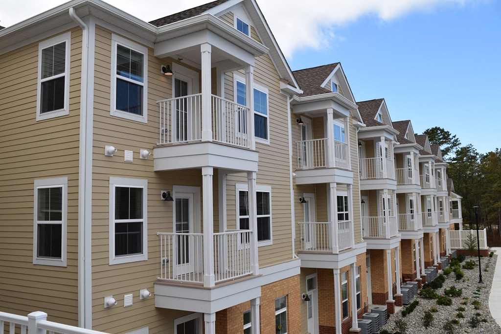 a row of town houses with balconies and railings