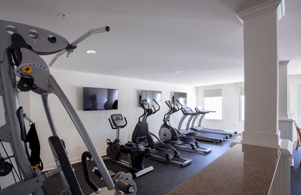 a row of exercise bikes in a gym