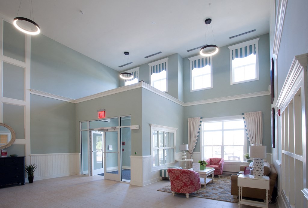 a large lobby with couches and chairs and high ceilings