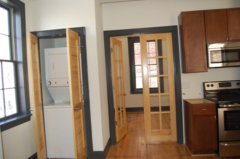 a kitchen with wooden doors and a stove and a refrigerator