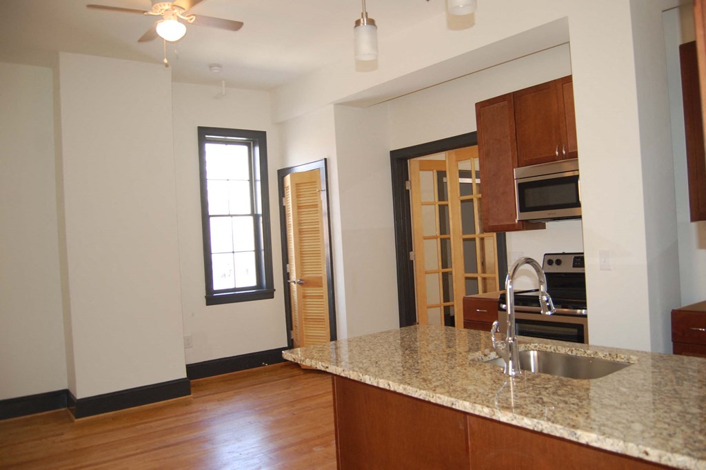 an empty kitchen with a granite counter top