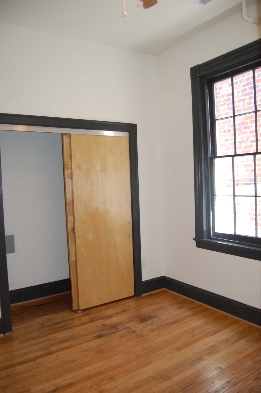 an empty room with a door and a window