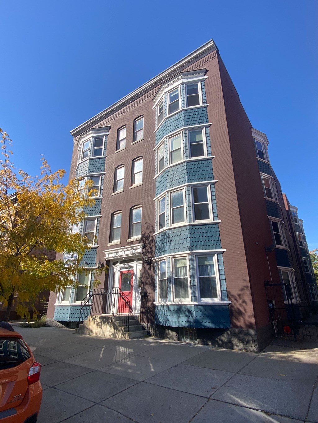 a building with a blue and brick facade on a city street