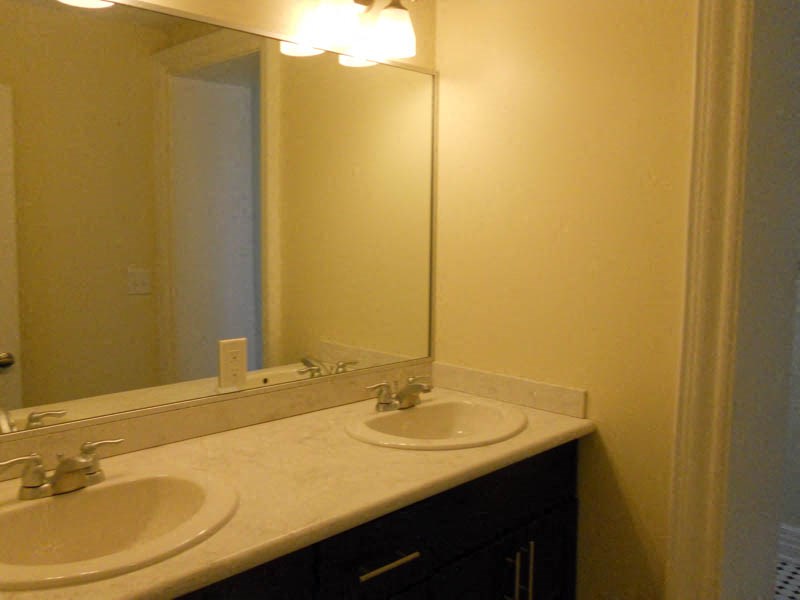 a bathroom with two sinks and a large mirror