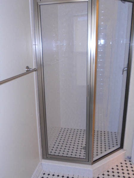 a shower in a bathroom with a glass door