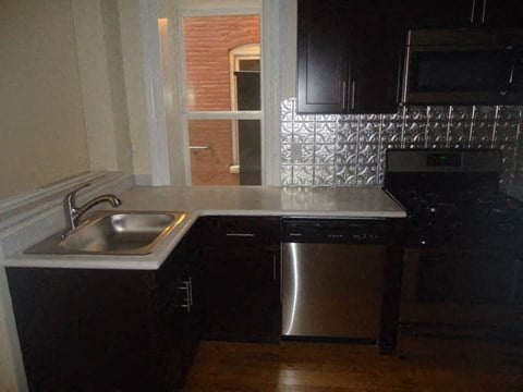 a kitchen with a stainless steel sink and a window