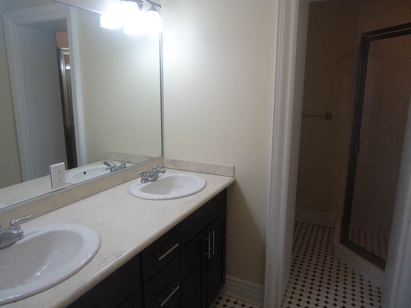 a bathroom with two sinks and a mirror