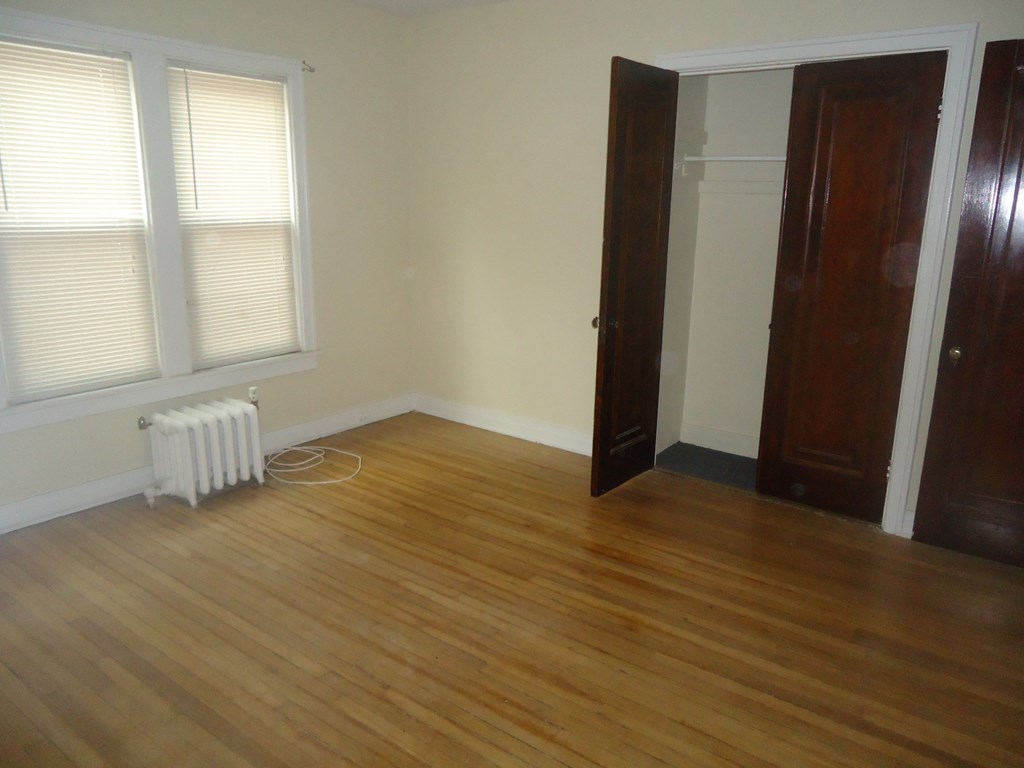 a living room with wood floors and a closet