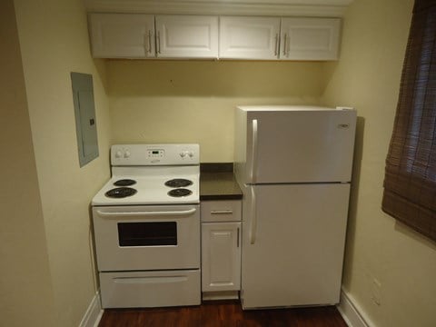 a kitchen with white appliances and a refrigerator