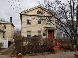 a yellow house with a red door