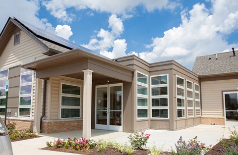the front of a building with windows and a sidewalk