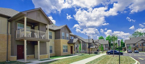 a row of homes with a blue sky in the background