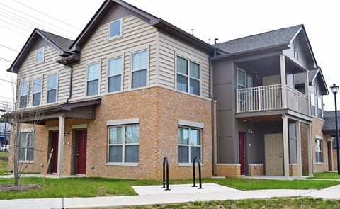 an apartment building with two stories and a balcony