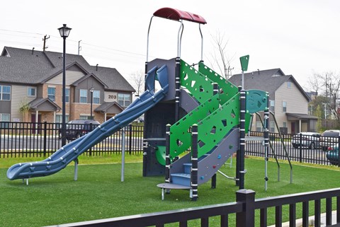 a playground with a blue and green swing set