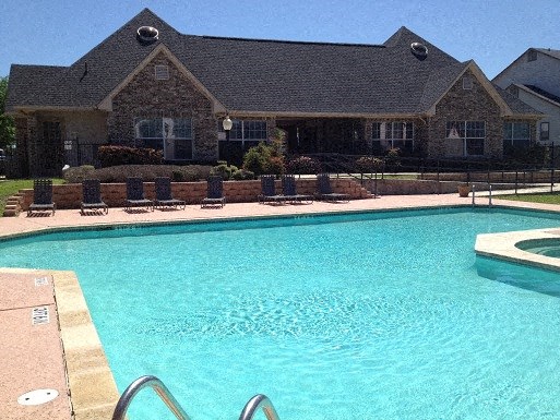 a large swimming pool in front of a house