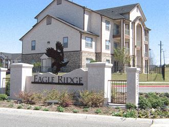 a eagle ridge sign in front of an apartment building