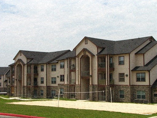 a large building with a fence in front of it