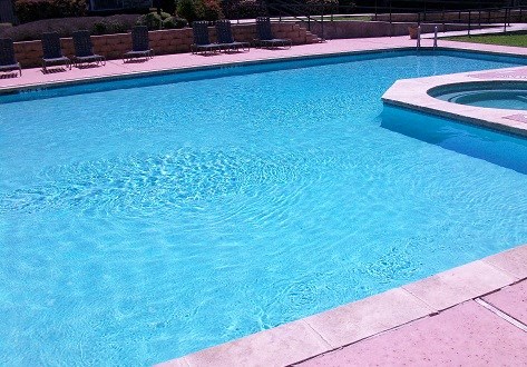 a large blue swimming pool in a backyard