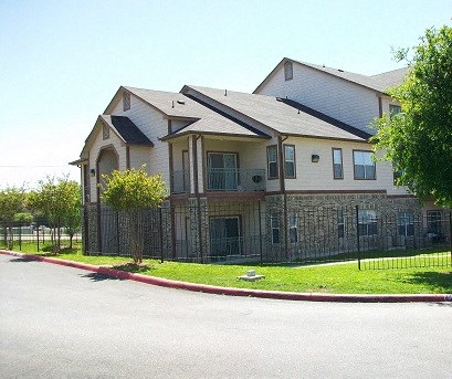 a large house with a fence in front of it