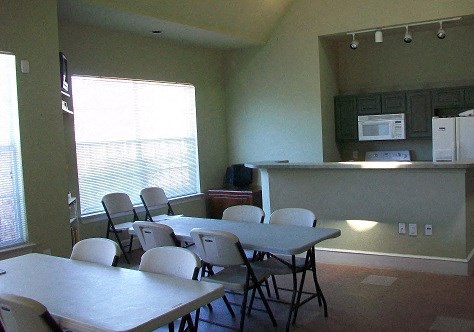 an empty dining room with a table and chairs