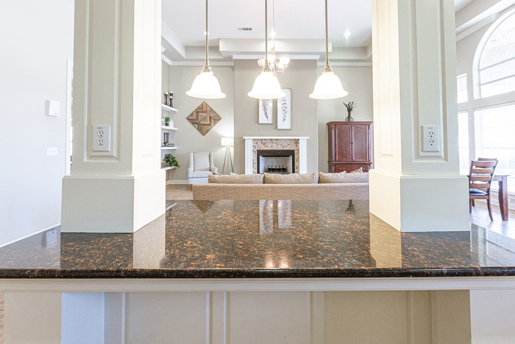 a view from the kitchen into the living room and dining room