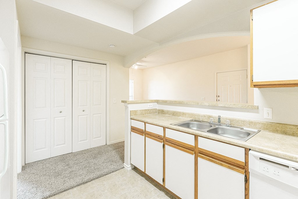 a kitchen with white cabinets and a sink