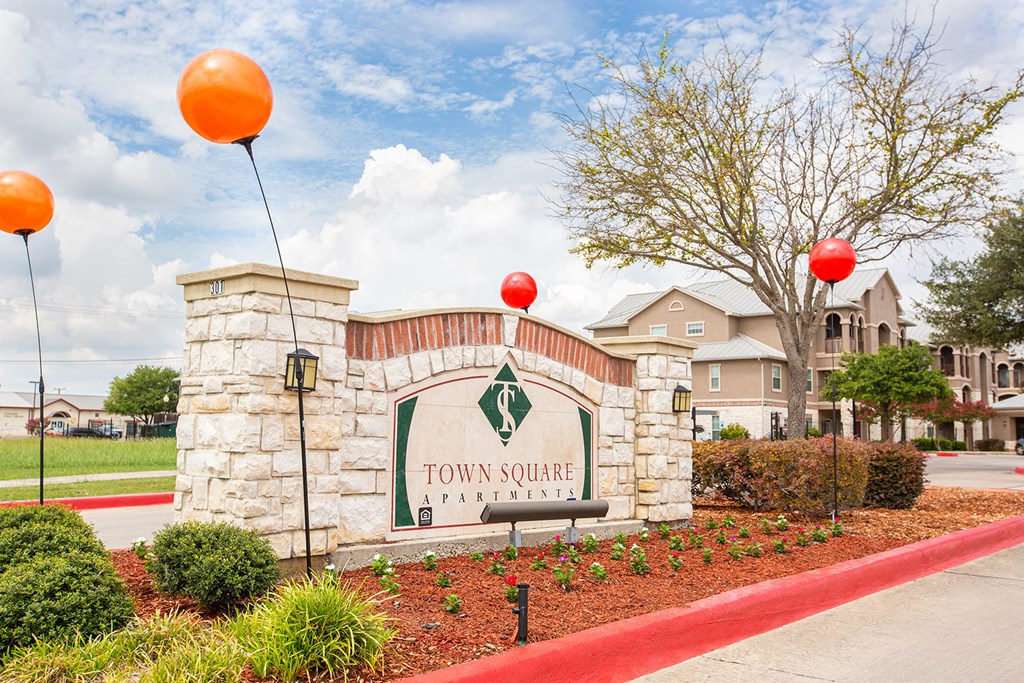 the entrance to town square at town center sign with balloons