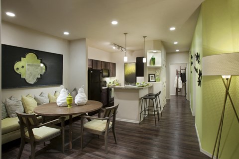 a dining room and kitchen with a table and chairs