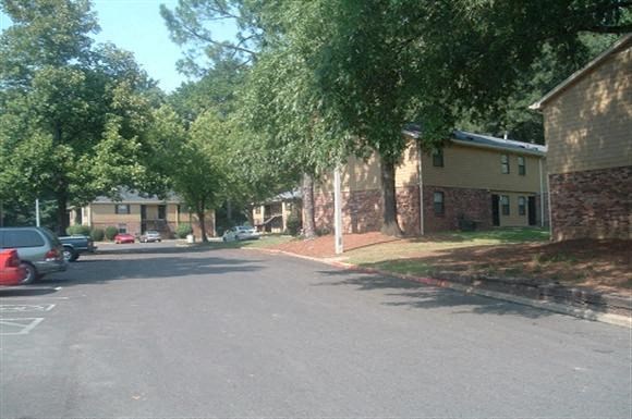 a street with cars parked in front of houses