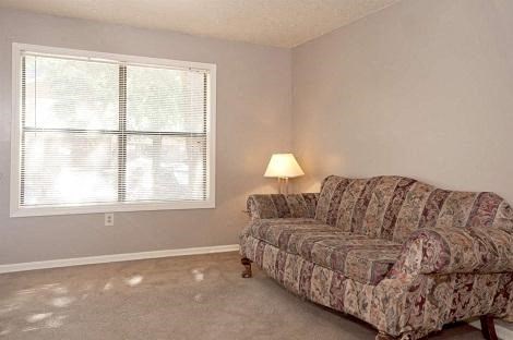 a living room with a couch and a window