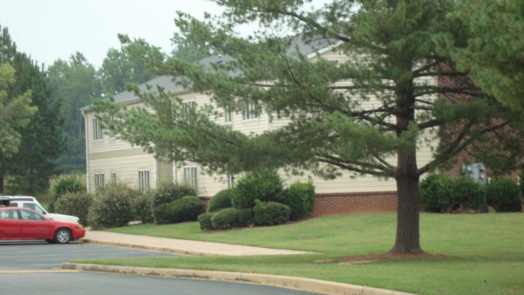 a house with a red car parked in front of it