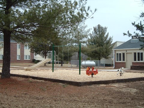 a playground with a fire hydrant in front of a house