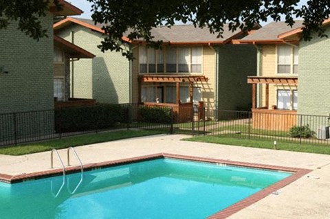 A swimming pool in front of a building.