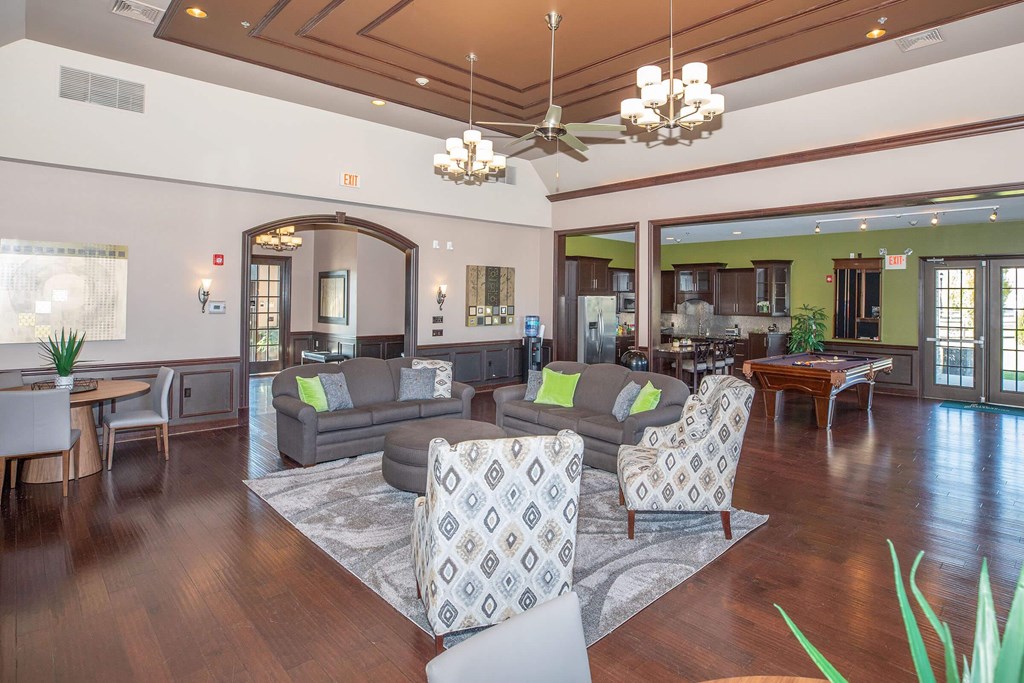 a living room and dining room with couches and chairs