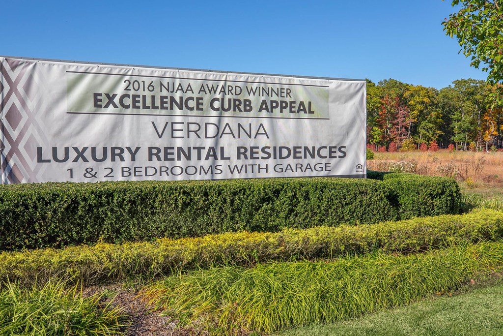 a sign for the excellence curb appeal luxury rental residences