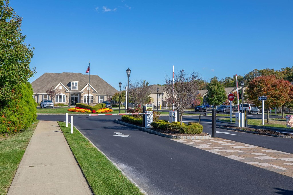 a street with a house on the corner of a road