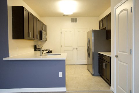 a kitchen with a counter top and a refrigerator