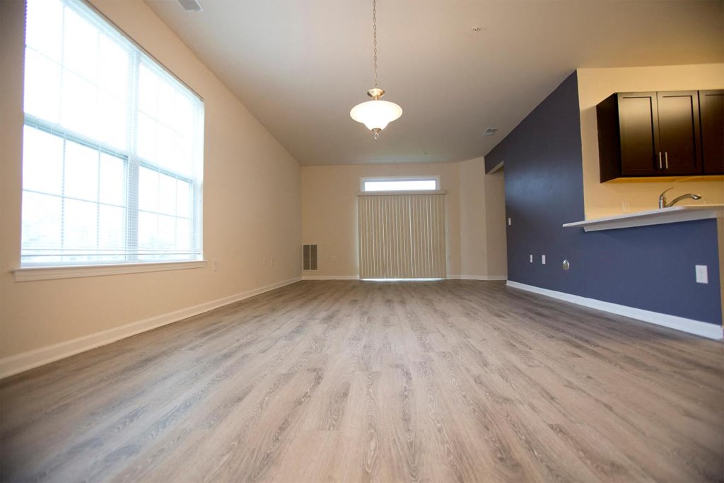 an empty living room with a hard wood floor